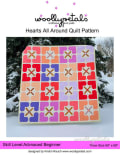 Woollypetals Hearts All Around Quilt with colorful heart blocks and X stars in snow