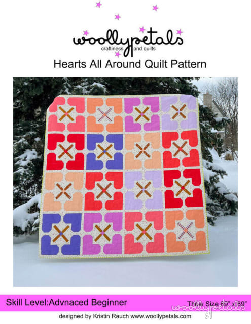 Woollypetals Hearts All Around Quilt with colorful heart blocks and X stars in snow