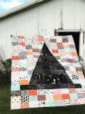 Woollypetals Something Wicked Quilt with black witch hat center and colorful patchwork blocks