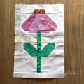 Woollypetals Echinacea Field quilt block with pink petals and green leaves