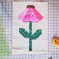 Woollypetals Echinacea Quilt Block with pink petals and green stem on polka dot background