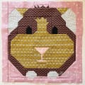 Woollypetals It's All Guinea Be Okay quilt block in brown, gold, and pink fabrics