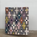 Woollypetals Moonrise quilt with patchwork crosses in gray background