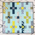 Woollypetals Moonrise quilt in light blue, yellow, navy, and gray fabrics