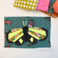 Woollypetals Moth Eclipse FPP pattern with neon yellow and floral fabric wings