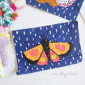 Woollypetals Moth Eclipse FPP pattern block with colorful moth design on navy moon fabric