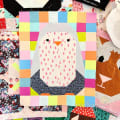 Woollypetals Penguin Social quilt block with colorful patchwork border