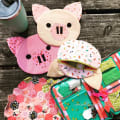 Woollypetals Pig Pouch sewing pattern in cream and pink fabrics with coordinating pouches