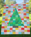 Woollypetals Something Wicked Quilt with green witch hat and colorful patchwork blocks