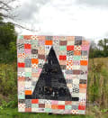 Woollypetals Something Wicked Quilt with black witch hat on colorful patchwork background