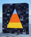 Woollypetals Something Wicked Quilt with witch hat design on beach