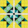 Woollypetals Starfy Mini quilt with geometric sawtooth star in yellow, teal, black, and green