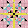 Woollypetals Starfy Mini quilt with pink, blue, black, and yellow geometric star design