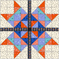 Woollypetals Starfy Mini quilt with giant sawtooth star in orange, blue, and turquoise