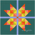 Woollypetals Starfy quilt with colorful star blocks on teal background