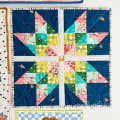 Woollypetals Starfy quilt in blue, pink, green, and yellow fabrics