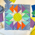 Woollypetals Stargeese Quilt block with colorful star center and flying geese