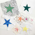 Woollypetals To the Stars FPP Pack showing colorful star blocks on fabric squares