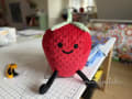 Woollypetals Strawberry Pillow plush craft sitting on grid paper