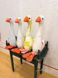 Woollypetals Silly Goose stuffed geese with fabric bodies and orange beaks on display shelf