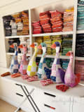 Woollypetals Silly Goose stuffed geese in patchwork fabrics displayed on shelf