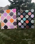 Woollypetals Floored quilts displayed outdoors in pink and black colorways