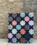 Woollypetals Floored quilt with black star blocks and colorful patterned diamonds