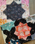 Woollypetals Floored quilt showing fabric swatches and star block layout