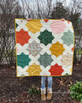 Woollypetals Floored quilt with colorful stars and white background