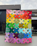 Woollypetals Floored quilt displayed on house exterior in rainbow colors
