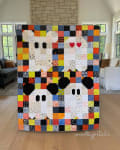 Woollypetals Ghost Party quilt with colorful patchwork blocks and black ghost appliqués