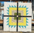 Woollypetals Wash Your Paws quilt with turquoise, yellow, and patterned fabric blocks