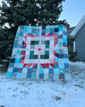 Woollypetals Wash Your Paws quilt displayed outdoors in snow