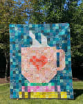 Woollypetals Book Date Patchwork Quilt with blue border and colorful center blocks