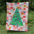 Woollypetals Oh Christmas Tree quilt with green tree and patchwork blocks