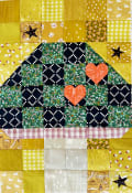 Woollypetals Capped quilt featuring house-shaped patchwork blocks in yellow and black fabrics