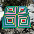 Woollypetals Clogged quilt with concentric square blocks and red hearts