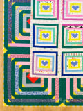 Woollypetals Clogged quilt with colorful heart blocks and geometric borders