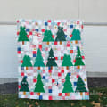Woollypetals Enchanted Forest Quilt with green trees and patchwork blocks