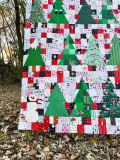 Woollypetals Enchanted Forest Quilt with green trees and patchwork blocks