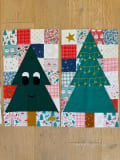 Woollypetals Enchanted Forest Quilt with green tree appliqués and festive patchwork