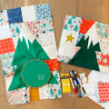 Woollypetals Enchanted Forest Quilt with green tree blocks and holiday fabrics