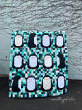 Woollypetals Penguin Social quilt with penguin appliqués on patchwork background