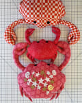 Woollypetals Coco the Crab stuffed pattern displayed flat on grid background