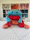 Woollypetals Coco the Crab stuffed plush in blue stars and red checkered fabrics