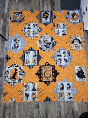 Woollypetals Floored quilt with orange and black medallion blocks
