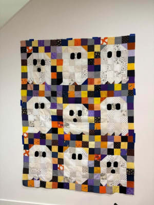 Woollypetals Ghost Party quilt with nine white ghost blocks on colorful patchwork background