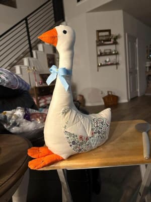 Woollypetals Silly Goose stuffed goose with orange beak and feet, wearing a blue bow
