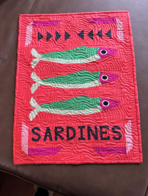 Woollypetals Sardine Tin FPP quilt with green fish on bright pink background