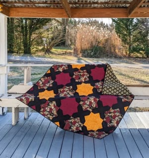 Woollypetals Floored10 quilt with colorful patchwork star blocks